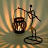 Lantern Lady Set Candle Holder is inspired from traditional Bastar Arts & Crafts and its been blended in to closest imitation. The construction of the Candle Holder gives a dramatic look of shadow and light and feel in its appearance. The Candle holders can be used with LED Candles, Wax Candles, as well as decorative. The product is hand crafted & assembled in multiple layers of refined processes, by skilled artisans. Each Lantern is finished with multiple layers of coating, which makes it resistant, and gives it a longer shelf life. Each product is Quality checked at multiple layers and processes. Creatively this product can be used for various purpose and occasions, Can be used for Wedding Gift, Party Decoration, indoor and outdoor for lawns gardens etc. It is an ideal gift for a housewarming, an ideal gift for a colleague or friend. Light and Shadow effect gives it a perfect mood for decoration at various occasions. Candle Holder can be on the table for indoor and outdoor. Each set of 3 pcs packed in a brown corrugated box. Size 5 inches Available Colors - Matte Gold & Natural Cane Disclaimer - All products are handmade and are subject to variation. Not 2 products will be 100% same. All our products are handcrafted by skilled Artisans, Made in India.