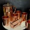 This elegant copper drinkware set serves as a sophisticated choice for luxury shaadi return gifts and trousseau.