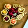 An exquisite peacock-themed metal diya set, perfect for premium shaadi return gifts and wedding ceremony decor.