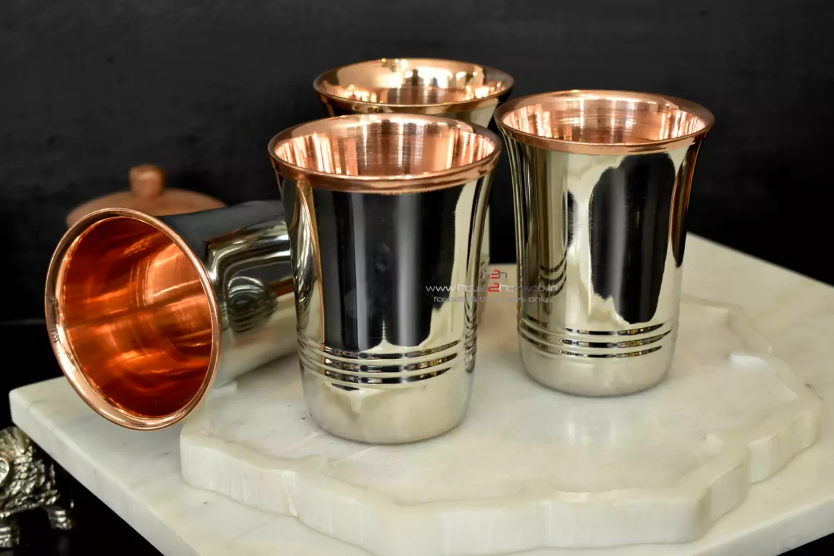 A set of elegant stainless steel tumblers with a warm copper interior finish and polished metal exterior.