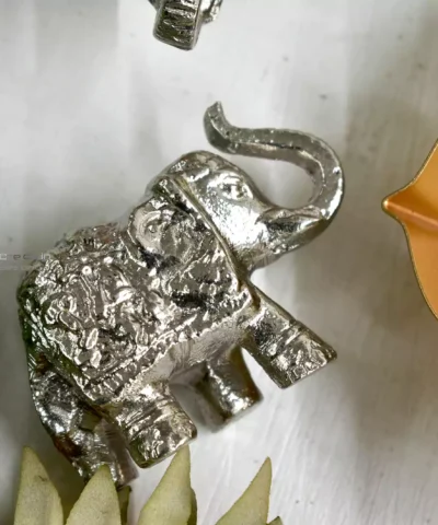 Small Silver Decorative Elephant, Silver Elephant Figurine, Decorative Elephant Sculpture, Elephant Ornament for Home Decor, Silver Elephant Centerpiece, Vastu Elephant Statue, Giftable Silver Elephant, Elephant Decor for Hampers, Metallic Elephant Home Accent, Elegant Elephant Decor Piece, Handcrafted Silver Elephant, Silver Elephant for Living Room, Lucky Elephant Decor, Feng Shui Elephant Decoration, Miniature Silver Elephant, Silver Elephant Desk Decor, Cultural Elephant Figurine, Silver Plated Elephant, Artisan Elephant Sculpture, Indian Themed Elephant Decor, Small Elephant, Agate, Candle Holder, Hamper Decorative, Hamper Filler, Silverware, German Silver Elephant, Diwali Gift, Deor, Silver Elephant, Mutli Color Agate, h2h, Decorative, Here are the keywords separated by commas: Small Metal Elephant with Agate Stone for Gifting, Agate Stone Topped Elephant for Hampers, Decorative Metal Elephant with Agate for Gifts, Miniature Metal Elephant with Agate for Hamper Packaging, Agate Decor Elephant Statue for Gift Baskets, Metal Elephant Figurine with Agate for Gifting, Small Agate Stone Elephant for Hampers, Agate-Topped Metal Elephant for Gift Sets, Elephant Ornament with Agate Stone for Hampers, Agate Embedded Metal Elephant for Gift Packaging, Metal Elephant with Agate Accents for Hampers, Agate Stone Decor Elephant for Gift Wrapping, Artisan Metal Elephant with Agate Stone for Gifts, Agate Crystal Elephant Figurine for Hampers, Unique Agate Topped Elephant for Gifting, Small Elephant with Agate Stone for Gift Boxes, Metal Elephant with Agate Gemstone for Hamper Decoration, Handcrafted Agate Stone Elephant for Gifts, Agate Decorated Mini Elephant for Hamper Gifts, Metal Elephant with Agate Crystal for Gift Baskets