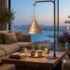 An elegant cone-shaped metal hanging lamp from featuring a gleaming gold finish and delicate geometric cutwork patterns.