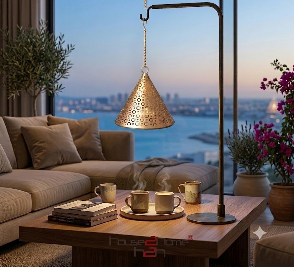 An elegant cone-shaped metal hanging lamp from featuring a gleaming gold finish and delicate geometric cutwork patterns.