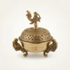 Intricately carved brass incense burner featuring a traditional peacock motif, crafted for premium home decor.