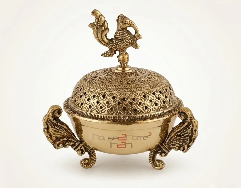 Intricately carved brass incense burner featuring a traditional peacock motif, crafted for premium home decor.
