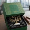An exquisite brass tree tabletop award accessory arranged neatly in a rigid green custom box.