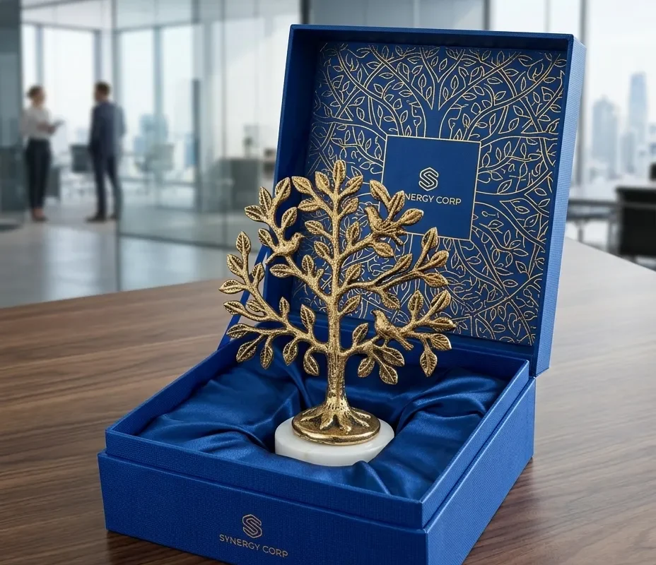 An elegant brass-tone metal tree of life decor piece featuring detailed leaves and a marble stand.