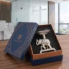 A detailed silver-toned metal elephant platter figurine carrying a scalloped bowl, presented inside a gift box.