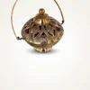 A handcrafted brass pot featuring intricate openwork patterns and a curved metal handle for a premium look.