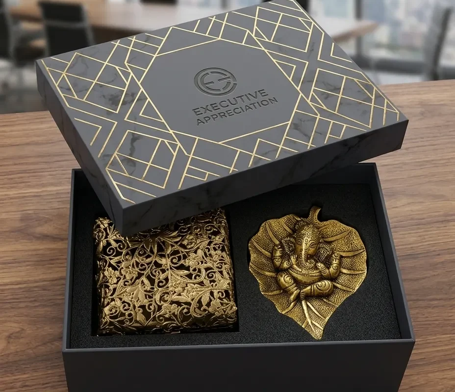 luxury metal gifting box containing a golden Ganesha idol leaf tray and ornate engraved utility container.