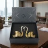 A premium dual-tone metal swan couple figurine set nested in a custom luxury presentation box.