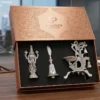 A German silver Venkateswara idol, ritual bell, and peacock diya set presented in a premium display box.