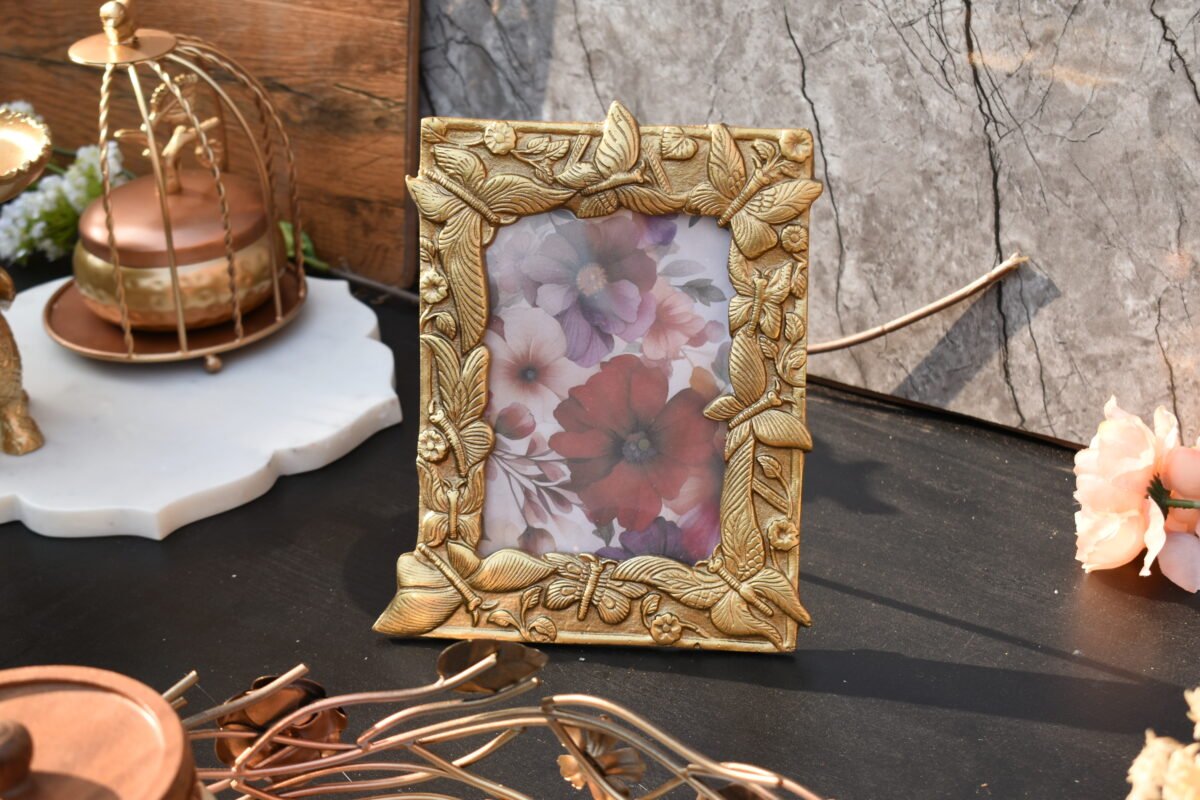 A decorative picture holder with a textured metallic gold coating designed by House2Home for tabletop display.