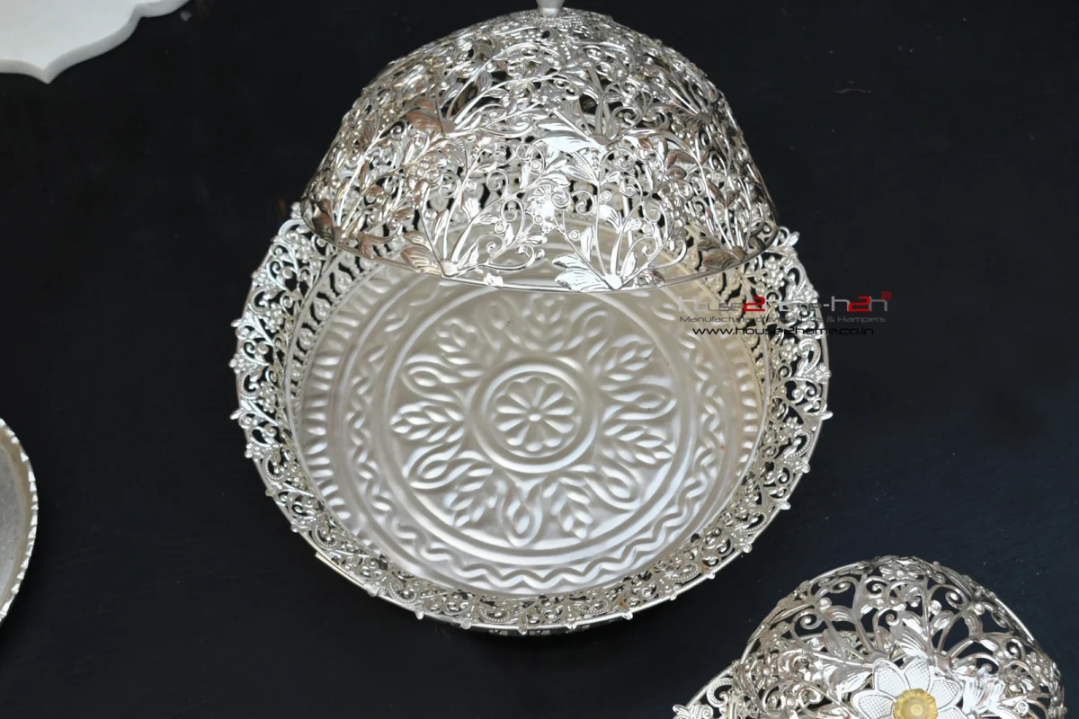 silver finish decorative metal bowl with intricate cutout styling, beautifully displayed as a luxury accent.