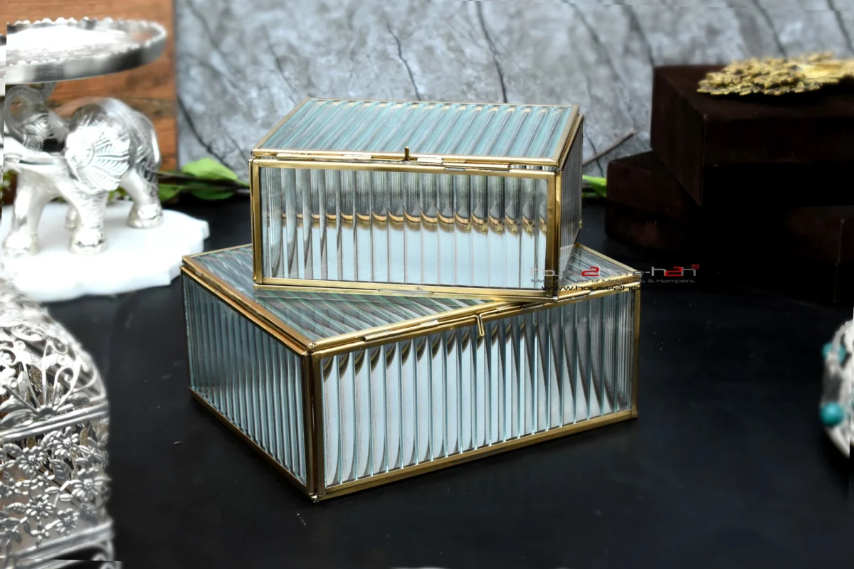 An exquisite glass and metal organiser box featuring a gold-toned frame and vertical ribbed glass texture.