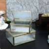 elegant glass storage box with a metallic brass finish frame, highlighting fine craftsmanship and modern appeal.