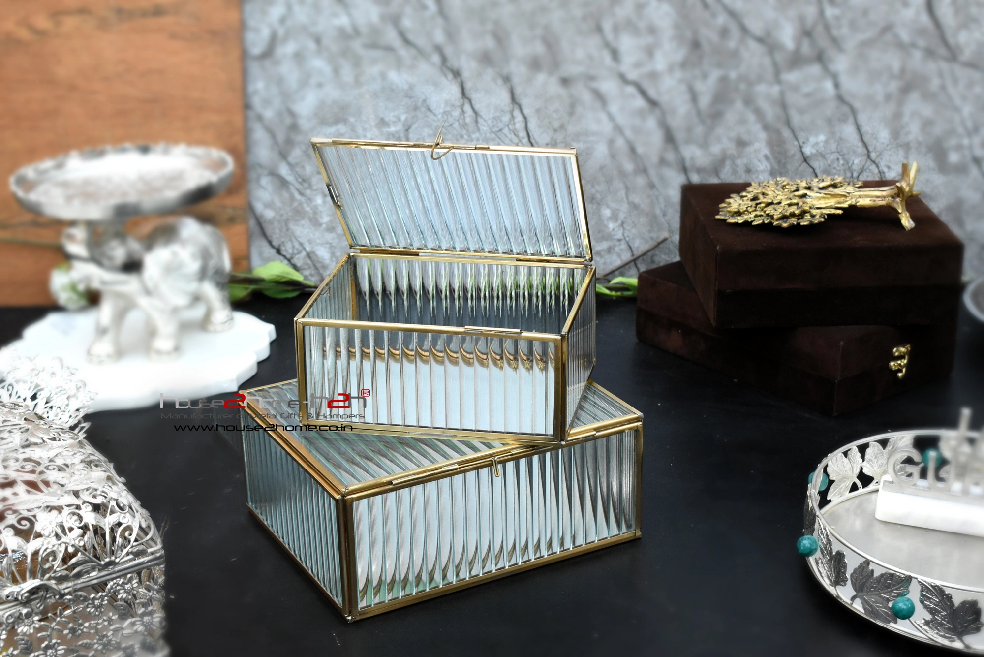 elegant glass storage box with a metallic brass finish frame, highlighting fine craftsmanship and modern appeal.