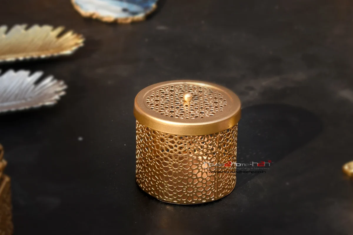 A stylish gold colored metal utility container with intricate Jali cutwork patterns by House2Home.