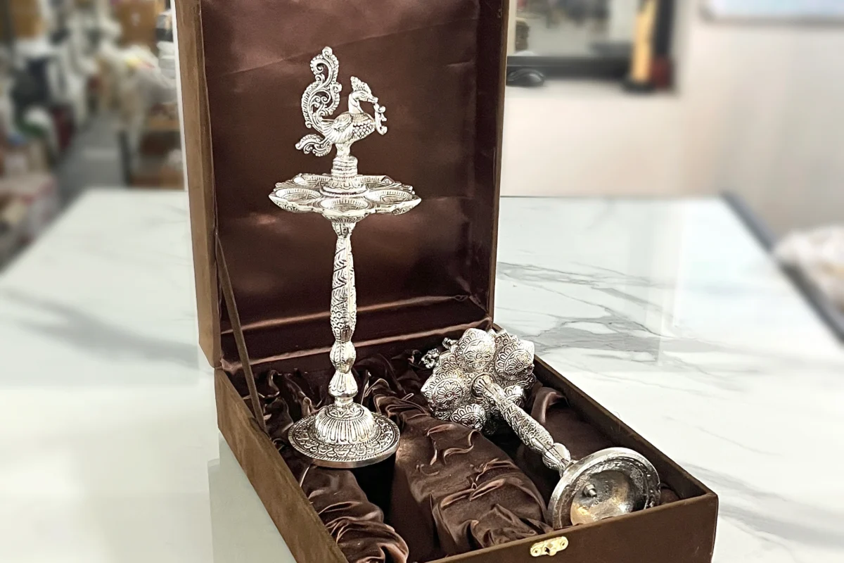 Traditional German silver peacock oil lamp in a decorative box, perfect for Diwali and auspicious Dhanteras gifting.