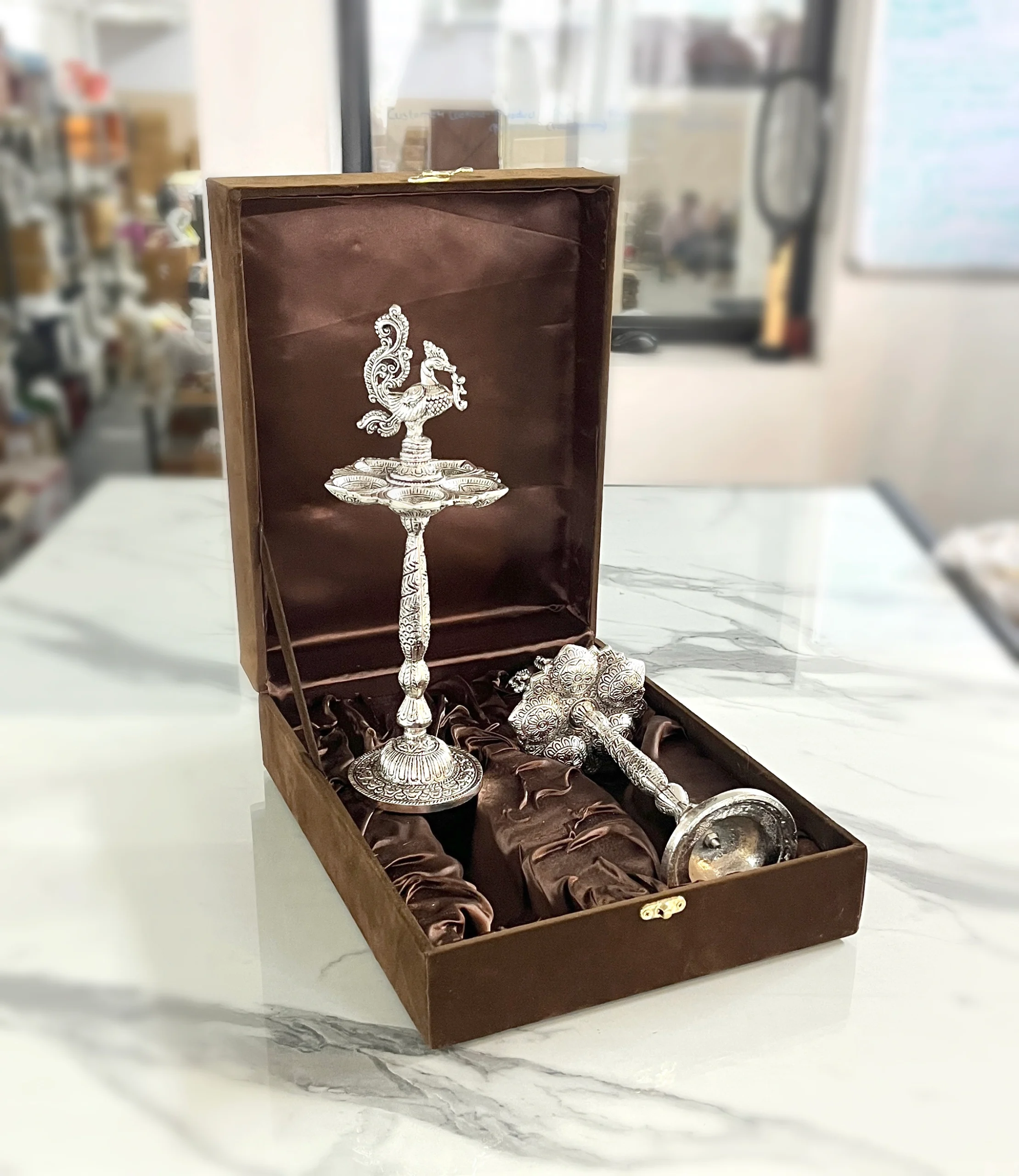 Traditional German silver peacock oil lamp in a decorative box, perfect for Diwali and auspicious Dhanteras gifting.
