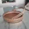 Round brass decorative basket with a matching handle, featuring intricate cutwork metal craftsmanship.