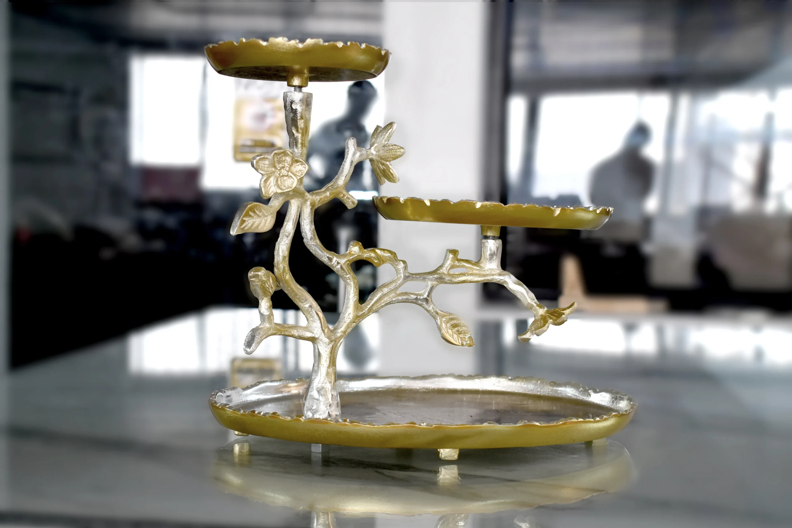 Silver and gold multi-tier floral serving stand arranged in an opulent Diwali and Dhanteras festive hamper.