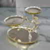 Silver and gold two-tone metal tree platter with three tiered trays and sculpted floral branches.