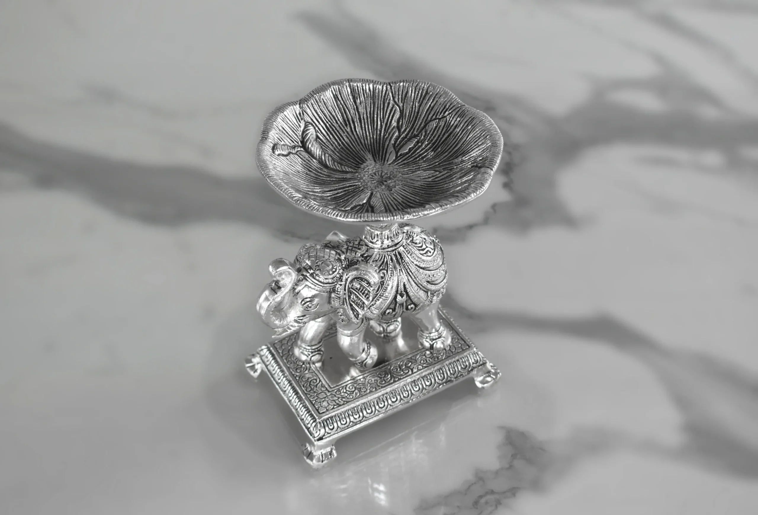 Silver royal elephant pedestal bowl arranged inside an opulent festive hamper for Diwali and Dhanteras gifting.