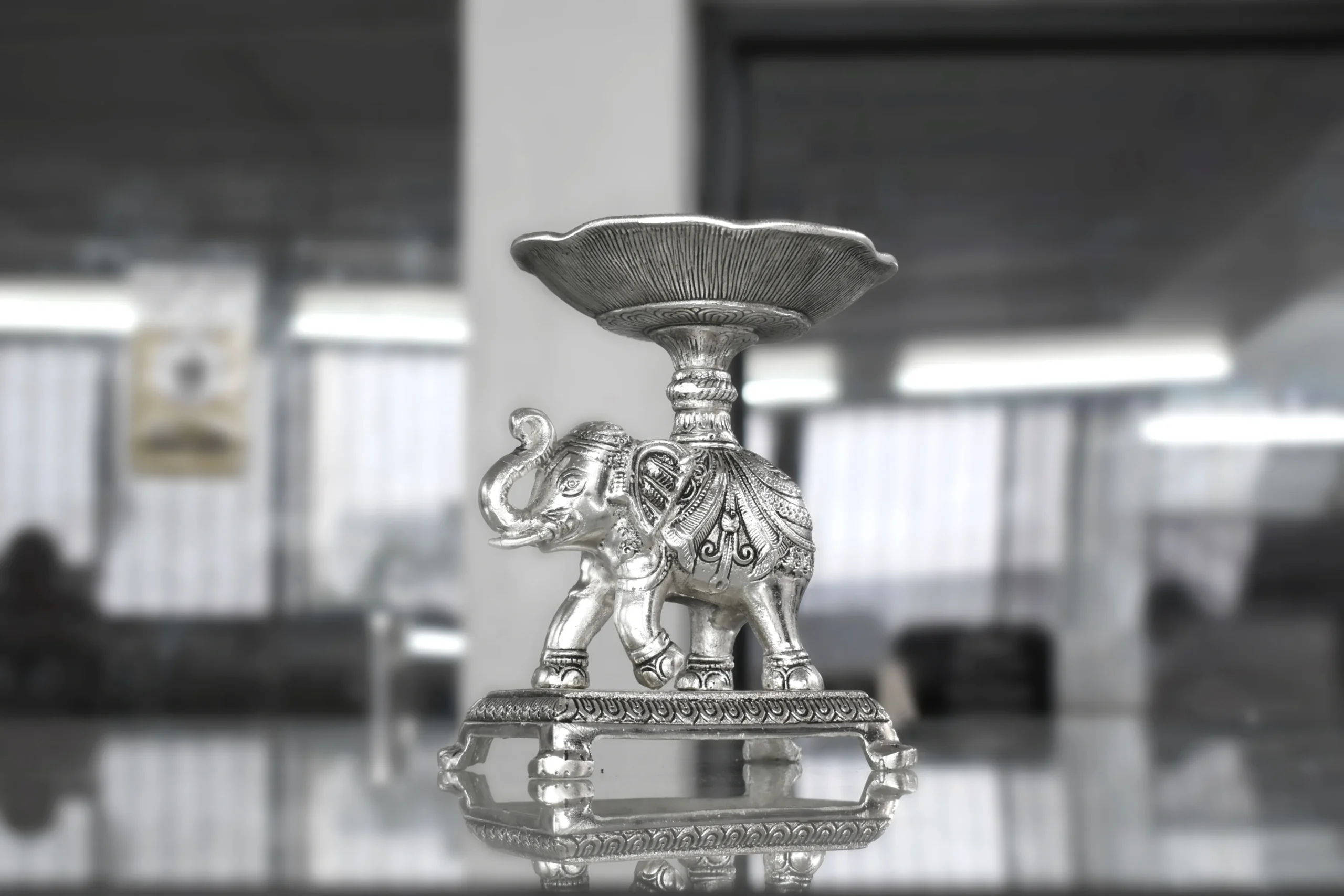 Silver elephant bowl stand styled as an auspicious wedding return gift favor for luxury shaadi hampers.