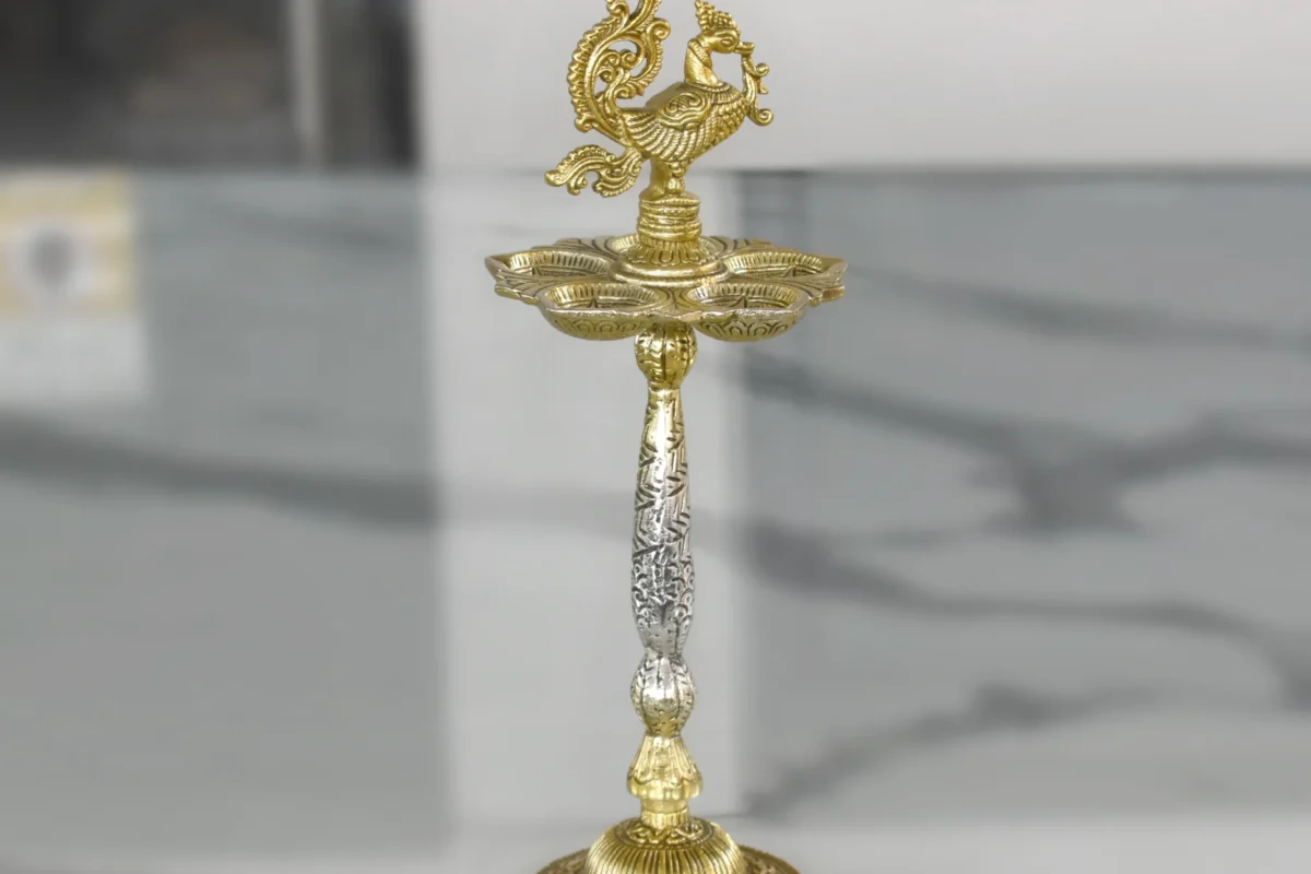 Silver finished peacock pooja diya stand styled for Griha Pravesh and housewarming hampers.