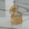 Handcrafted gold metal nest box with flower lid designed for premium corporate festive gifting hampers.
