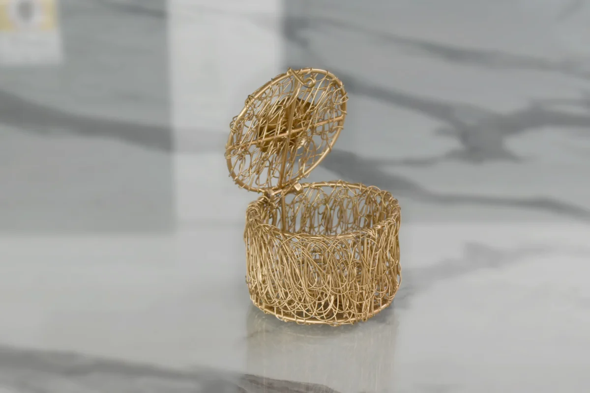 Handcrafted gold metal nest box with flower lid designed for premium corporate festive gifting hampers.