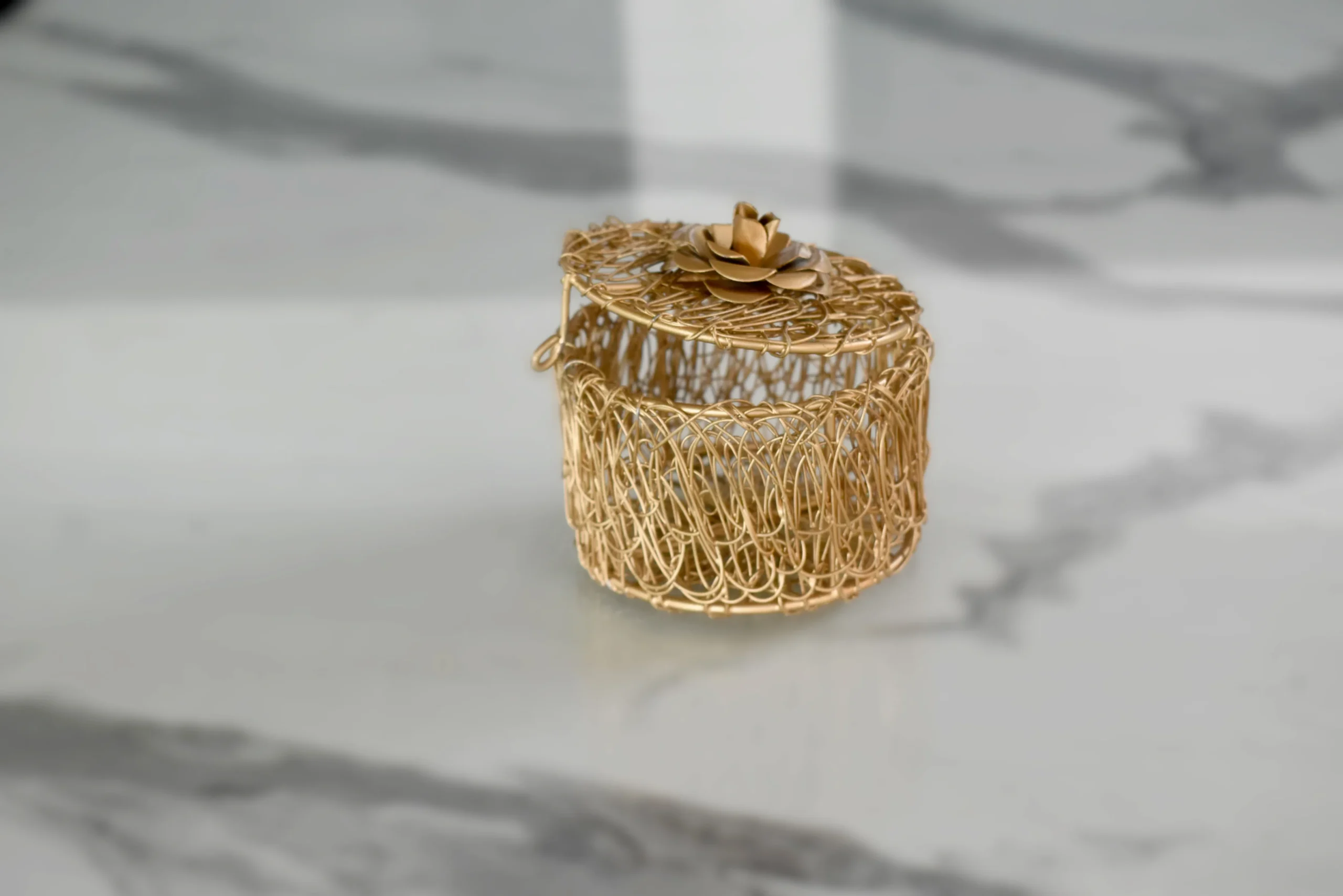 Decorative floral top metallic gift box styled in a festive Diwali gift hamper arrangement.
