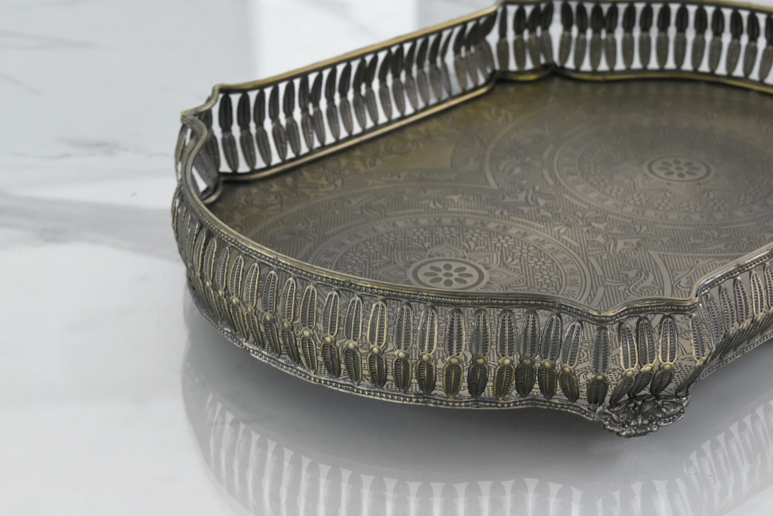 Vintage-style Moradabad brass vanity tray with intricate embossed floral patterns and a decorative pierced gallery rim