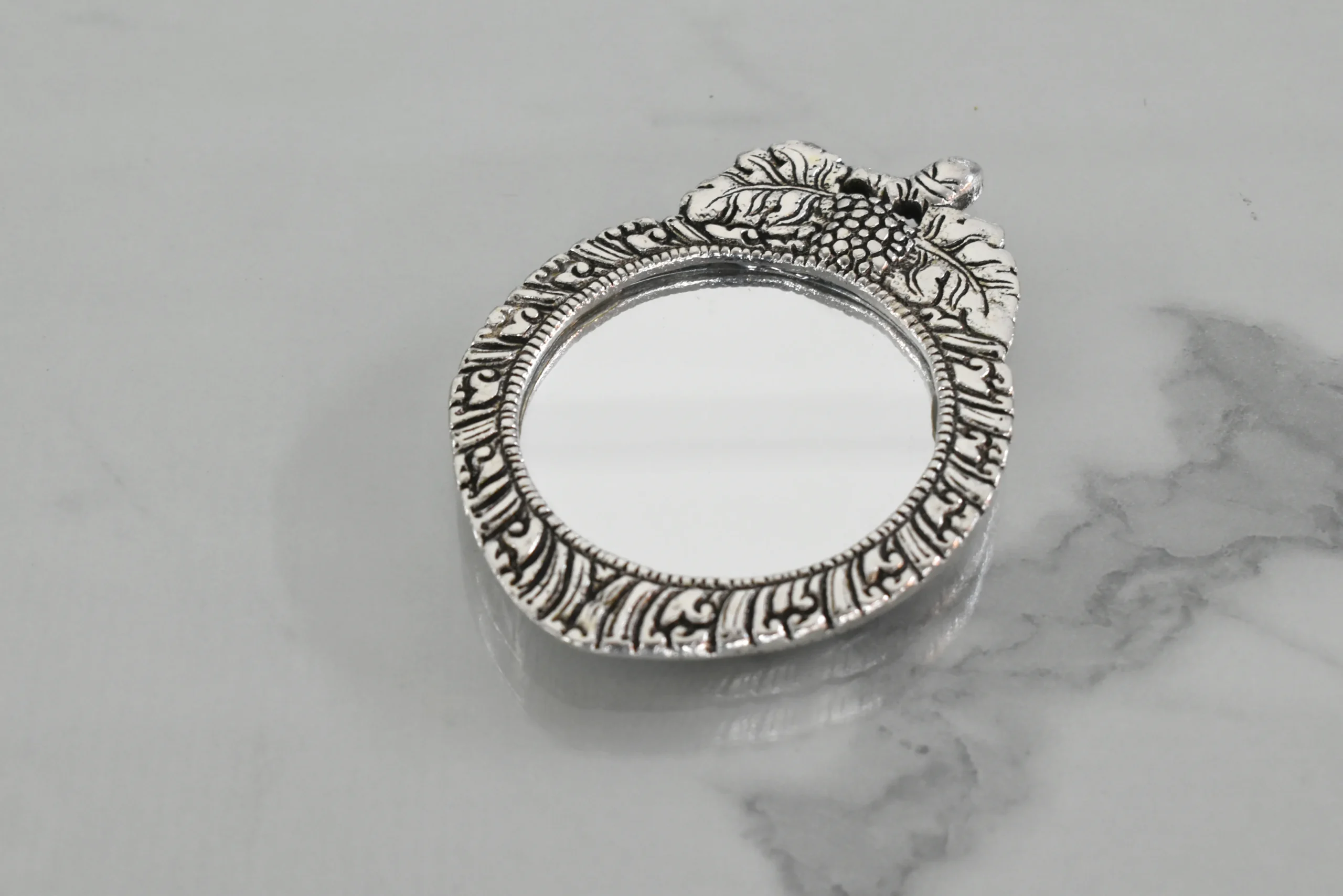 Traditional silver-plated vanity mirrors displayed for Griha Pravesh housewarming and religious ceremonies.