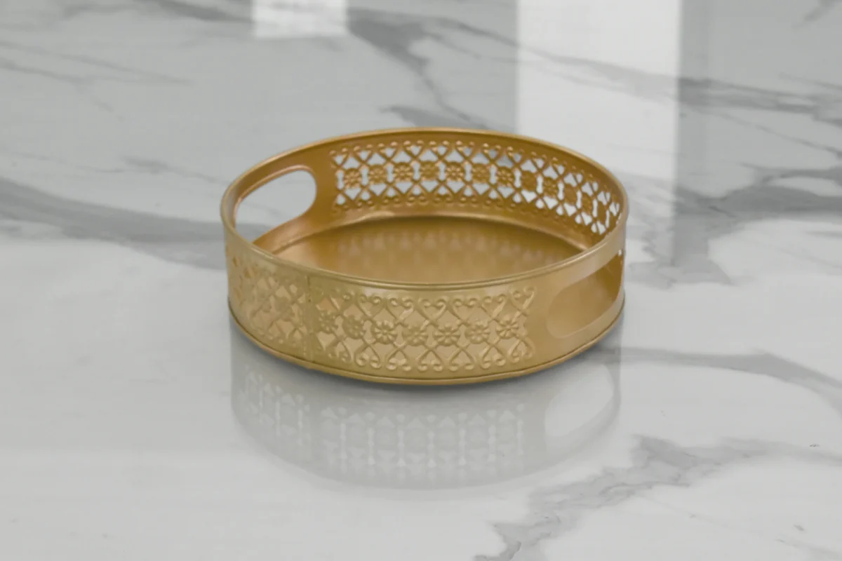 Round gold metal tray styled for luxury wedding return gifts and shaadi trousseau hampers.