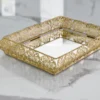 Ornate gold mirror tray styled for luxury wedding return gifts and shaadi trousseau presentations.