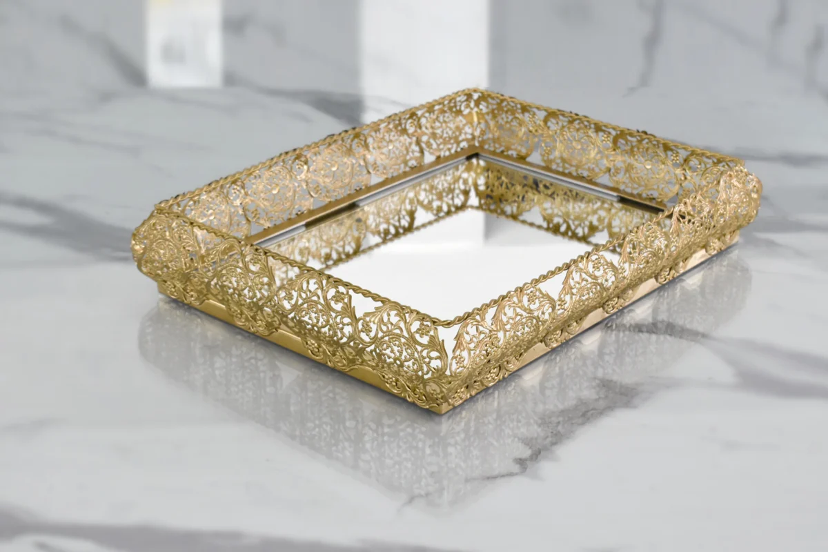 Ornate gold mirror tray styled for luxury wedding return gifts and shaadi trousseau presentations.