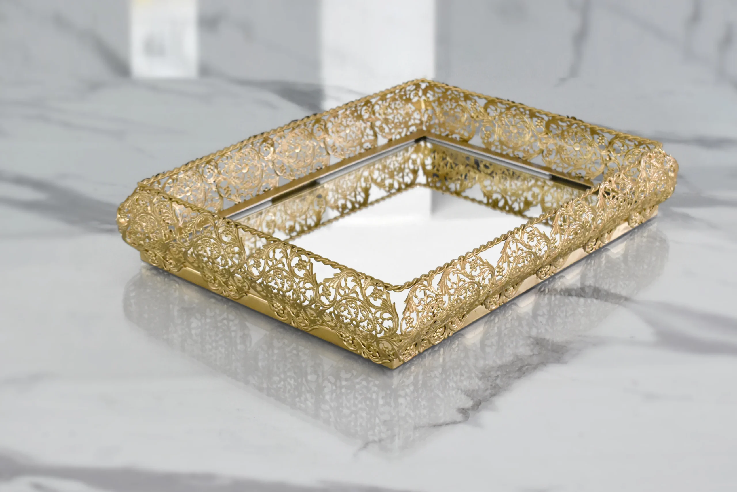 Ornate gold mirror tray styled for luxury wedding return gifts and shaadi trousseau presentations.