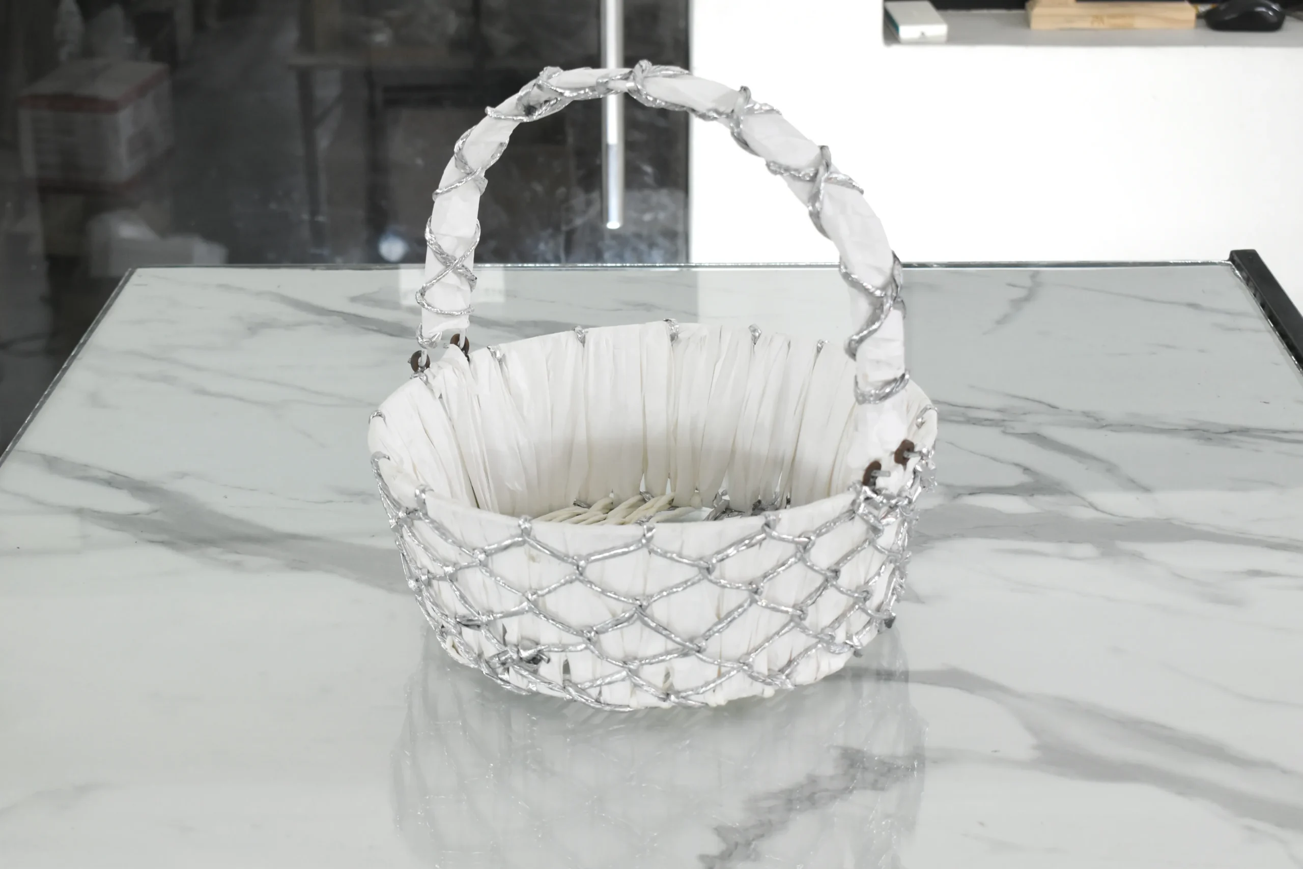 Silver wire mesh gift basket styled for luxury wedding trousseau packing and shaadi ceremony hampers.