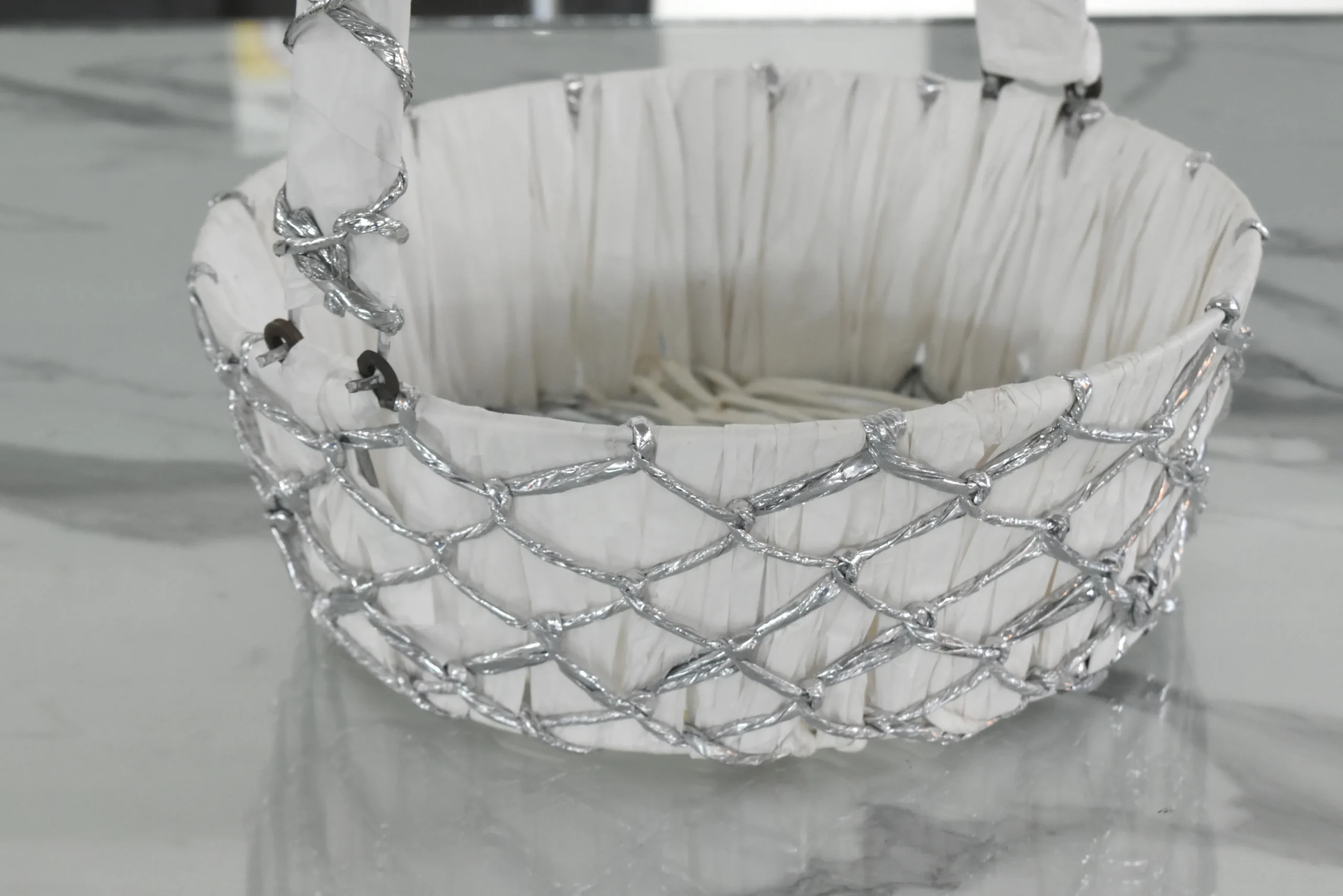 Ornamental silver mesh basket featured in a Diwali festive hamper and Dhanteras gift arrangement.
