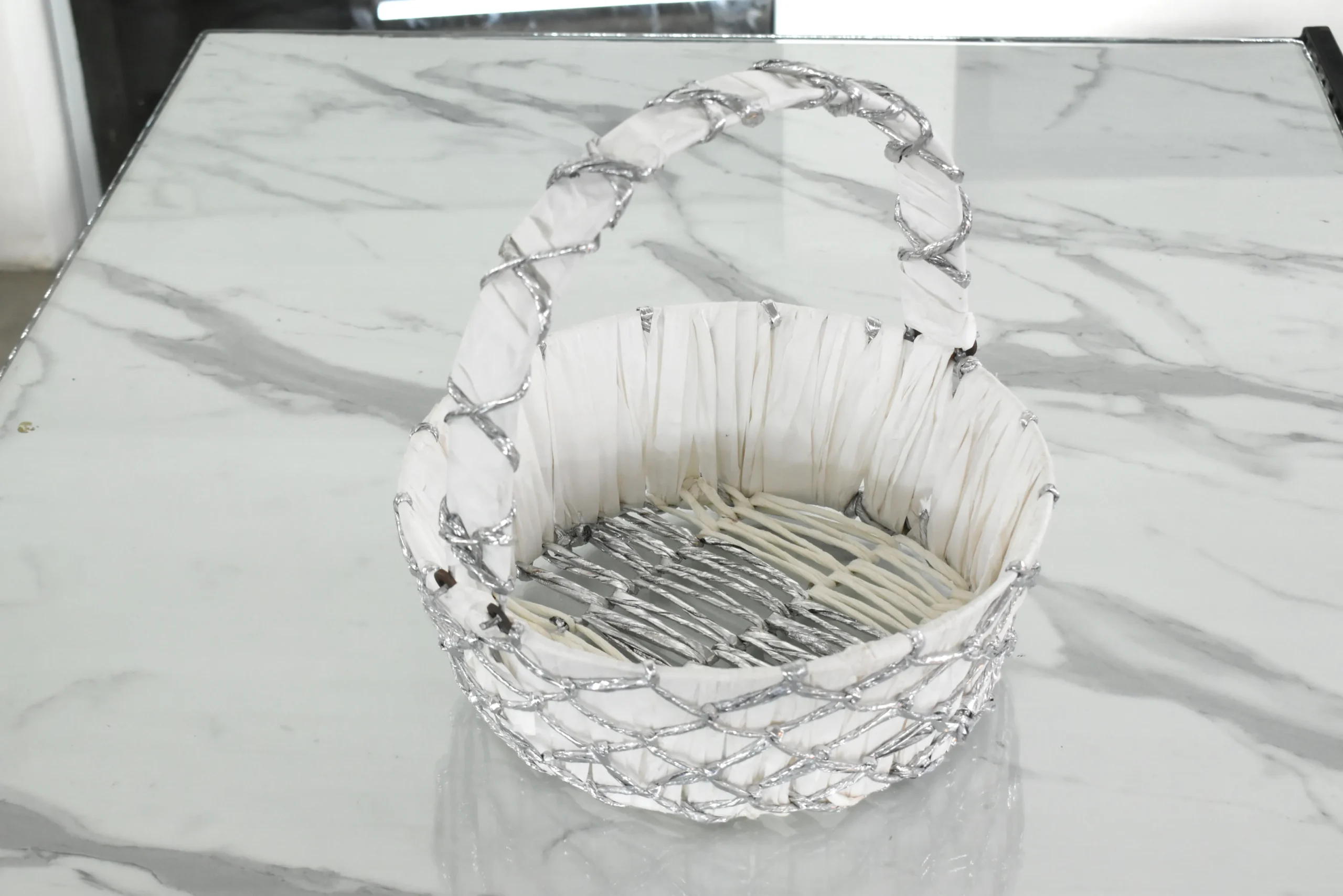 Silver wire mesh gift basket styled for luxury wedding trousseau packing and shaadi ceremony hampers.