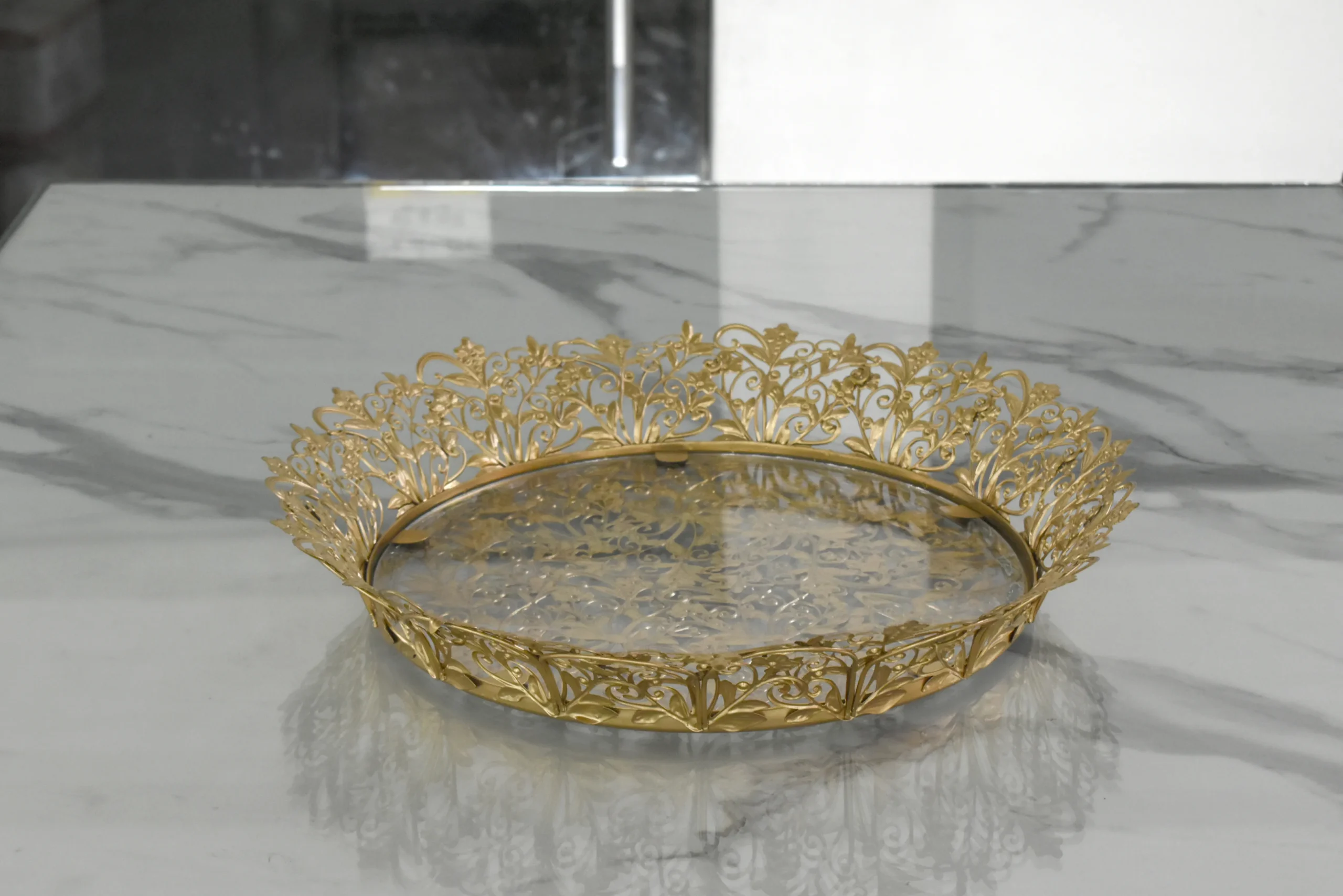 Festive round gold decorative tray arranged for Diwali gift hampers and auspicious Dhanteras celebrations.