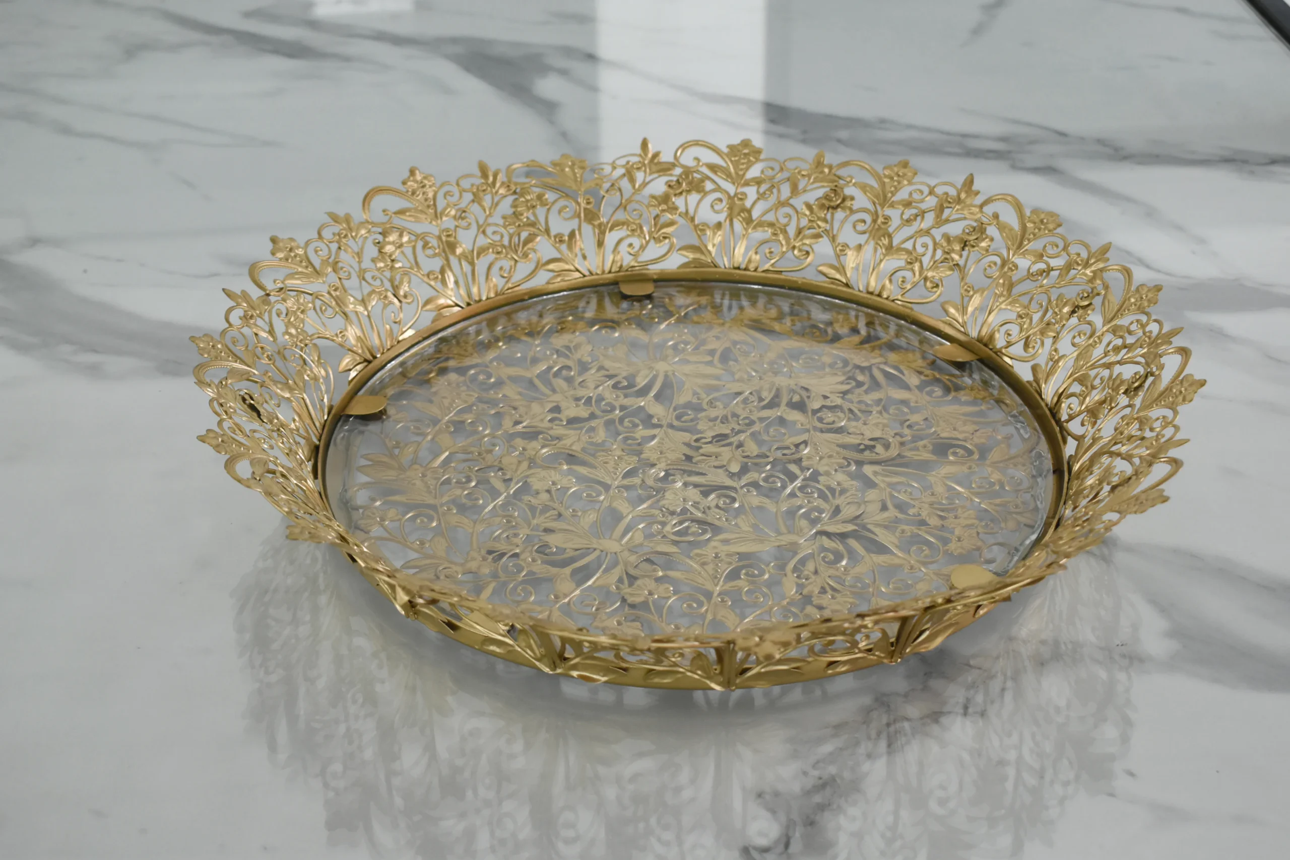 Ornate round gold metal mirror tray styled for luxury wedding return gifts and shaadi trousseau displays
