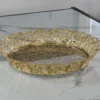 Elegant round gold metal tray displayed for Griha Pravesh housewarming and traditional religious ceremonies.