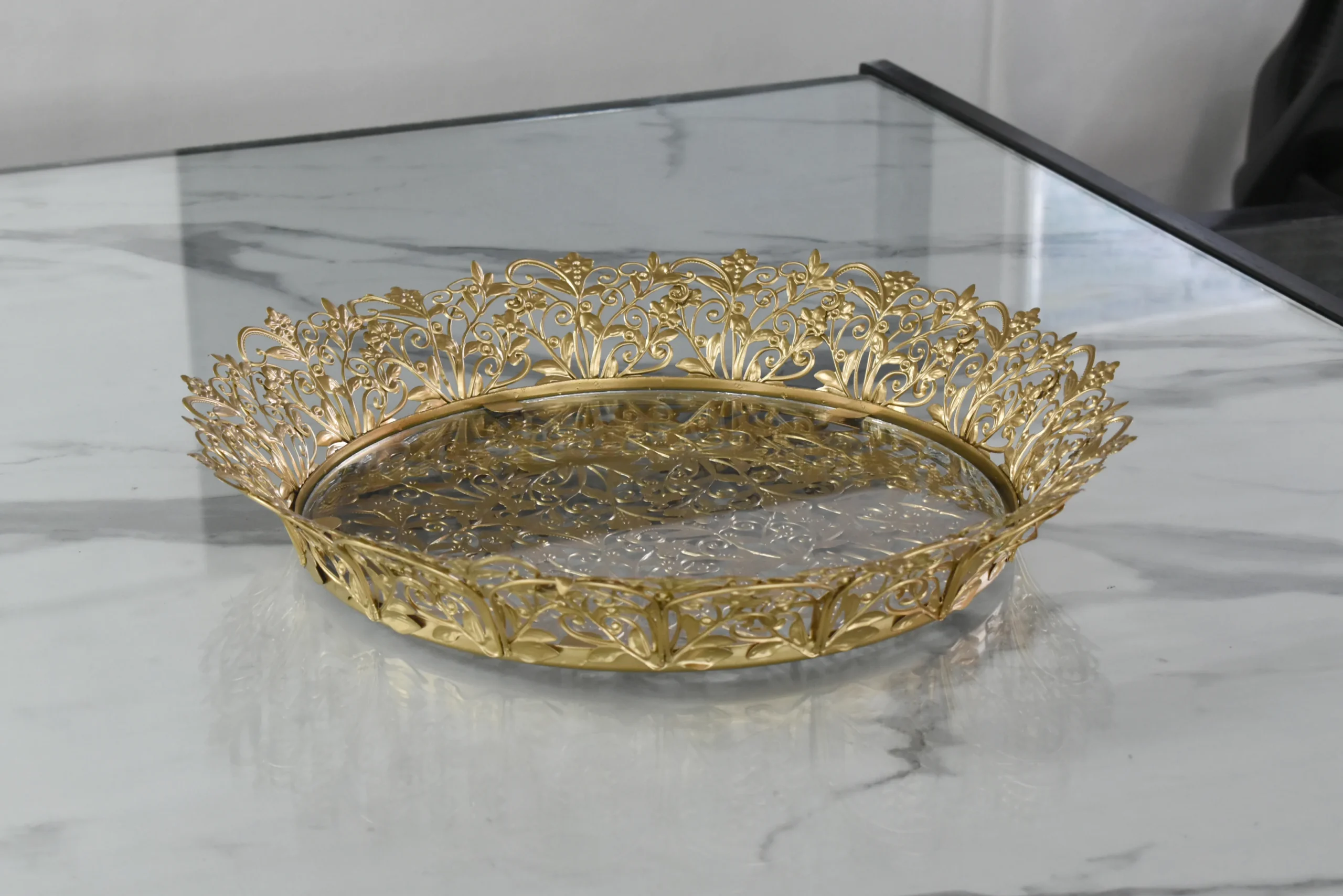 Elegant round gold metal tray displayed for Griha Pravesh housewarming and traditional religious ceremonies.