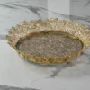 Festive round gold decorative tray arranged for Diwali gift hampers and auspicious Dhanteras celebrations.