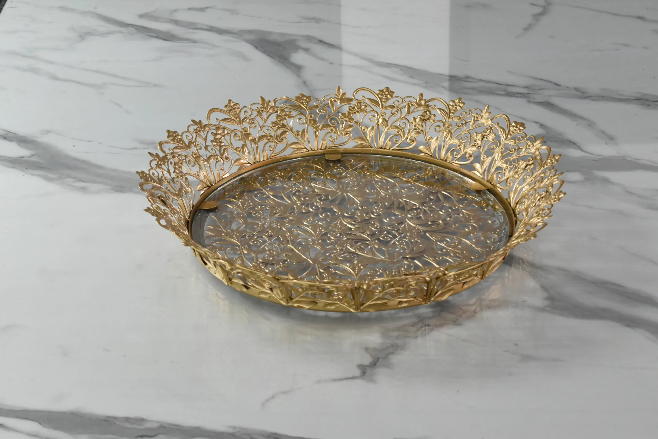 Festive round gold decorative tray arranged for Diwali gift hampers and auspicious Dhanteras celebrations.