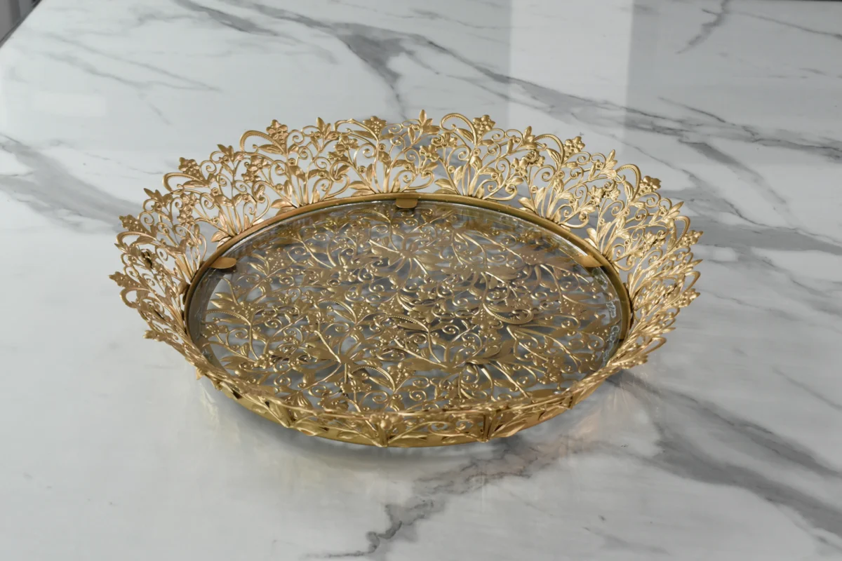 Ornate round gold metal mirror tray styled for luxury wedding return gifts and shaadi trousseau displays.