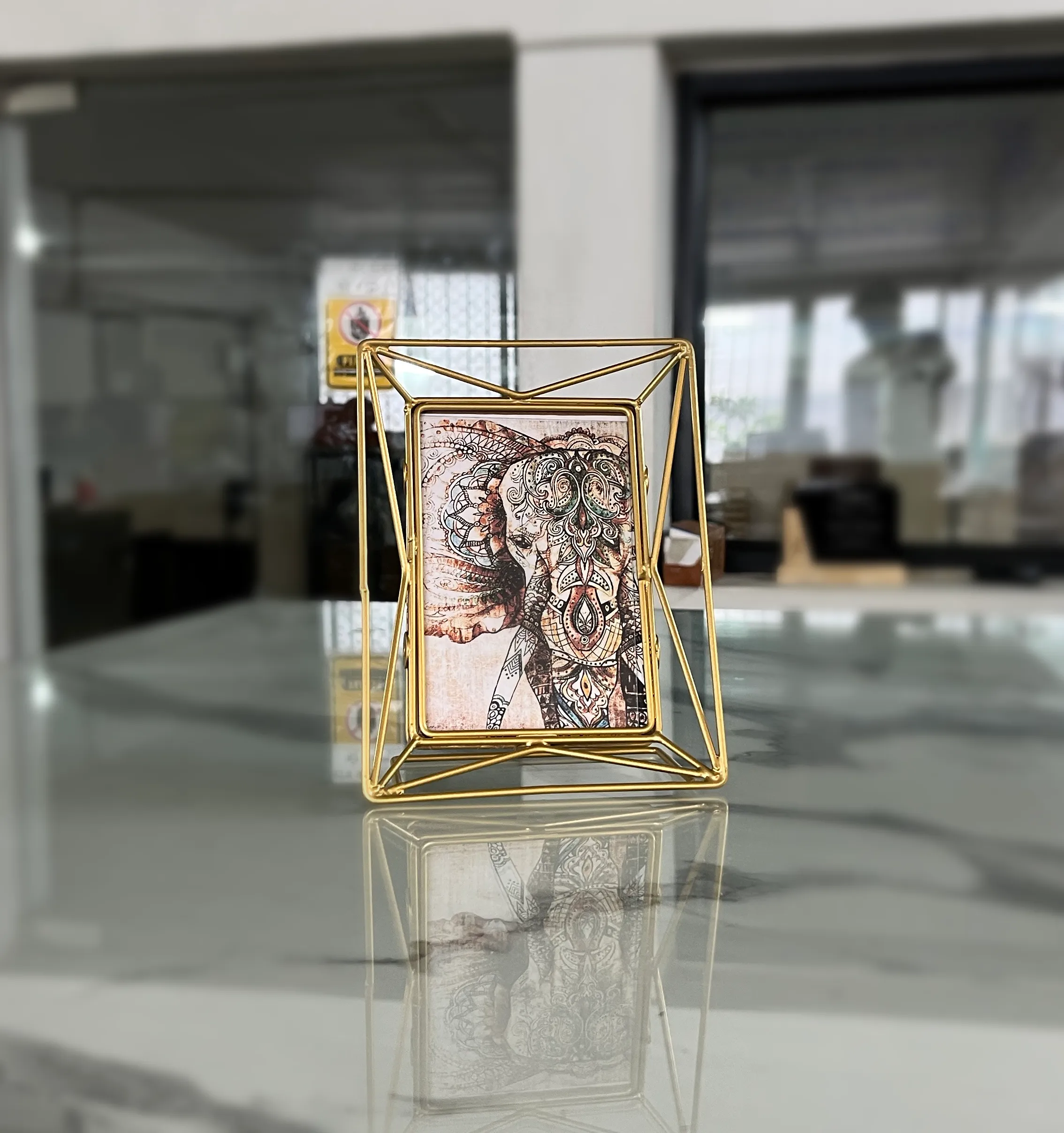 Elegant iron wire photo frame styled inside a luxury wedding return gift hamper for a traditional shaadi.